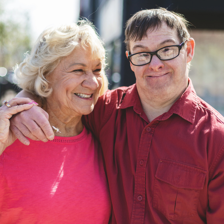 Mother hugging son who has Down syndrome.